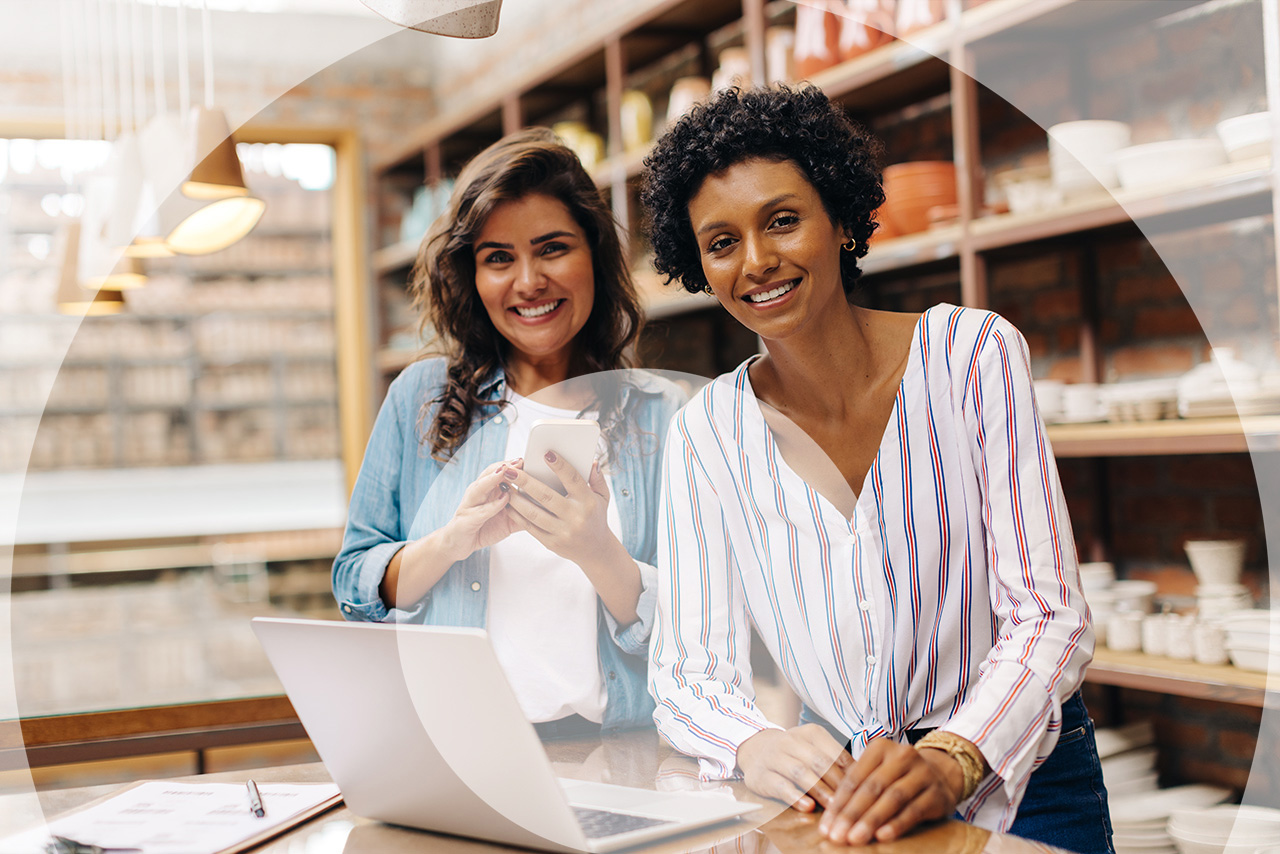 franchise consultants standing in front of laptop