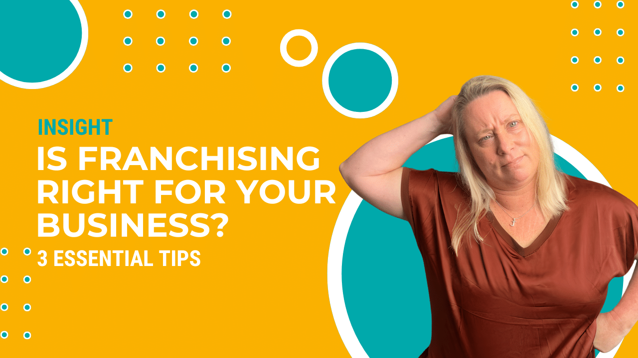 Julie standing by a sign saying is franchising right for your business